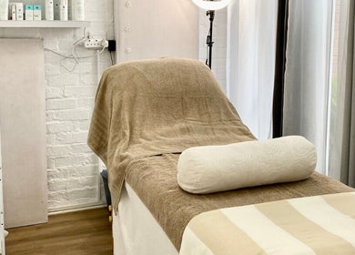 Relaxing massage room at MK Beauty Tokai, Cape Town, Western Cape, ZA with bed and products.