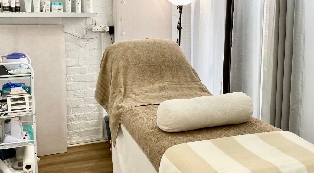 Relaxing massage room at MK Beauty Tokai, Cape Town, Western Cape, ZA with bed and products.