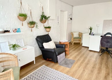 Relaxing interior of MK Beauty Tokai, Cape Town, Western Cape, ZA with plants, chairs, and desk.