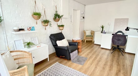 Relaxing interior of MK Beauty Tokai, Cape Town, Western Cape, ZA with plants, chairs, and desk.