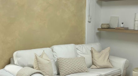 Comfortable white sofa with cushions at PALM, Montréal, Québec, CA, exudes calm and relaxation.