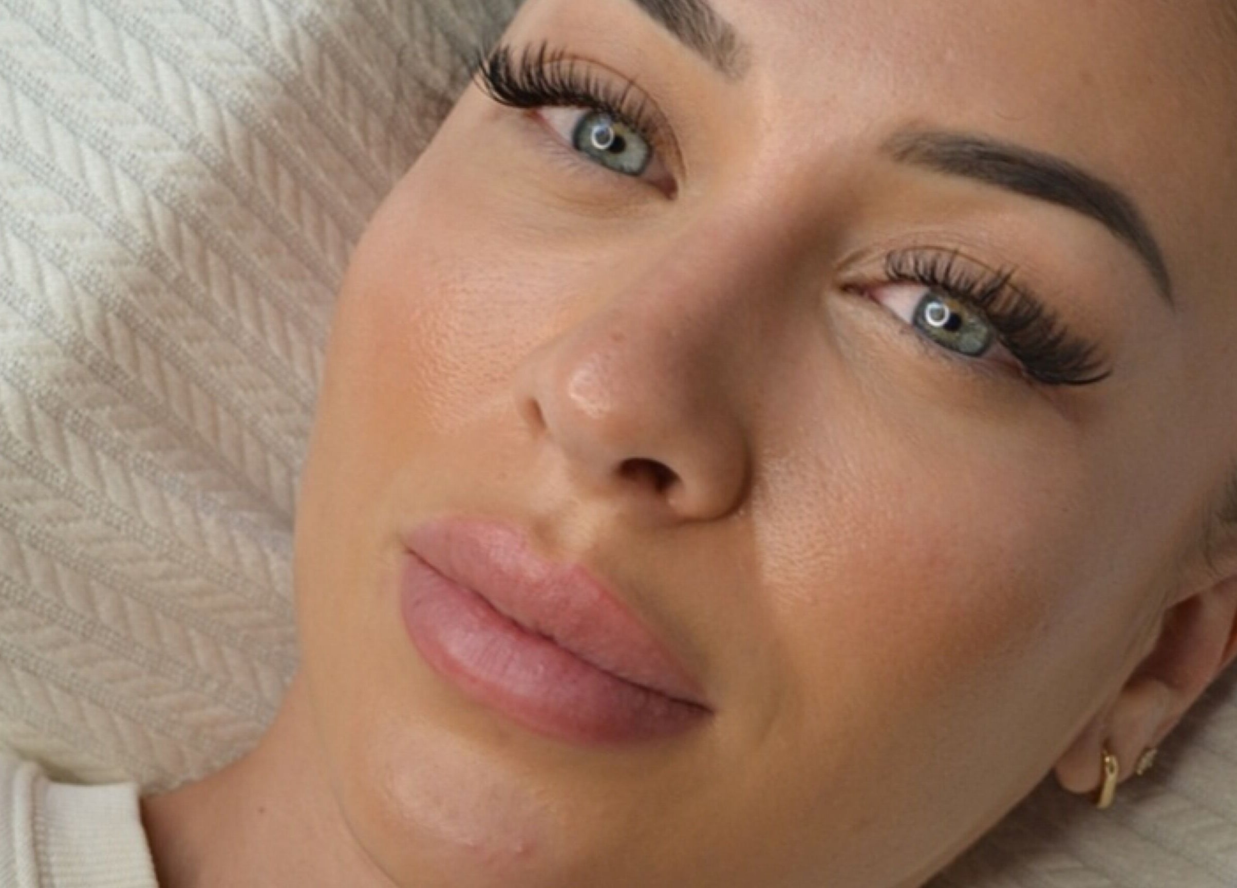Close-up of a serene face with flawless makeup and lashes at Palm, Montréal, Québec, CA.