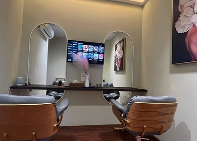 Elegant salon interior of Hairworx Co., Kuala Lumpur, with stylish mirrors and chairs for a luxurious experience.