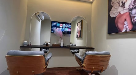 Elegant salon interior of Hairworx Co., Kuala Lumpur, with stylish mirrors and chairs for a luxurious experience.