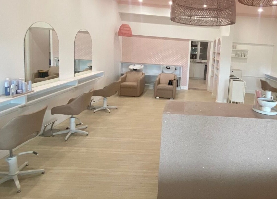 Bright, modern interior of Studio Black Innaloo in Innaloo, Western Australia, AU with salon chairs and mirrors.