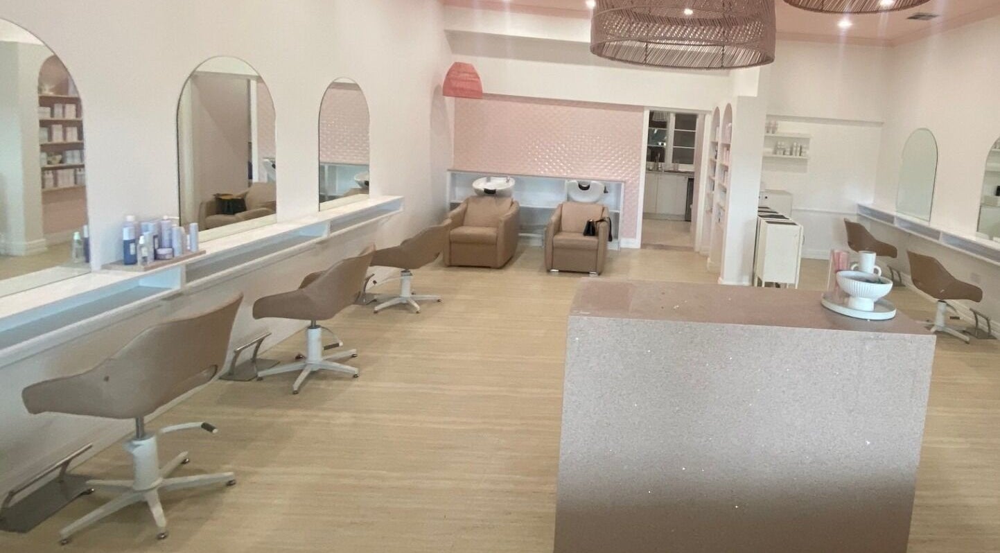 Bright, modern interior of Studio Black Innaloo in Innaloo, Western Australia, AU with salon chairs and mirrors.