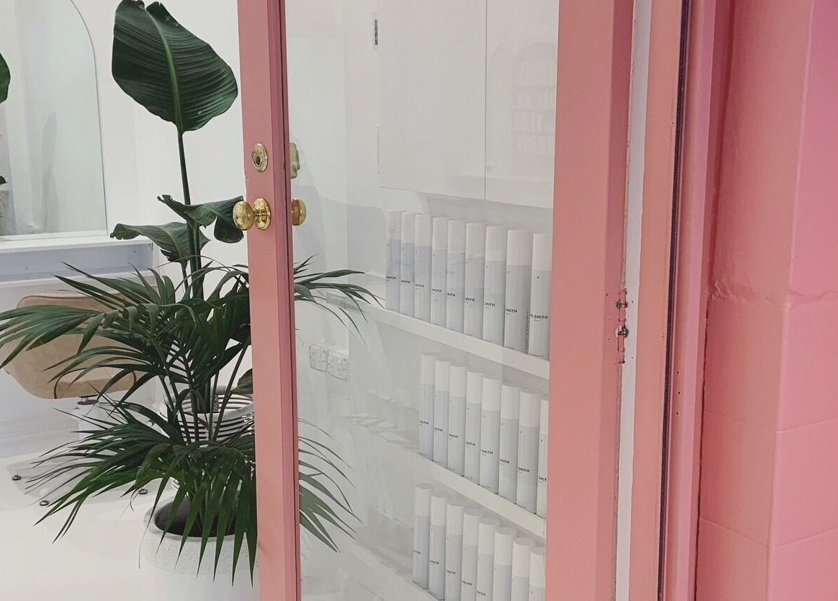 Stylish pink door with lush plants at Studio Black Innaloo, Innaloo, Western Australia, AU.