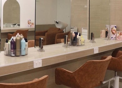 Stylish beauty station at Studio Black Cottesloe showcasing chic chairs and mirrors in Cottesloe, Western Australia, AU.