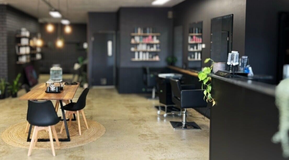 Cozy salon interior at Chelsea Maddison Hair, Leongatha, Victoria, AU, featuring sleek furniture and warm lighting.