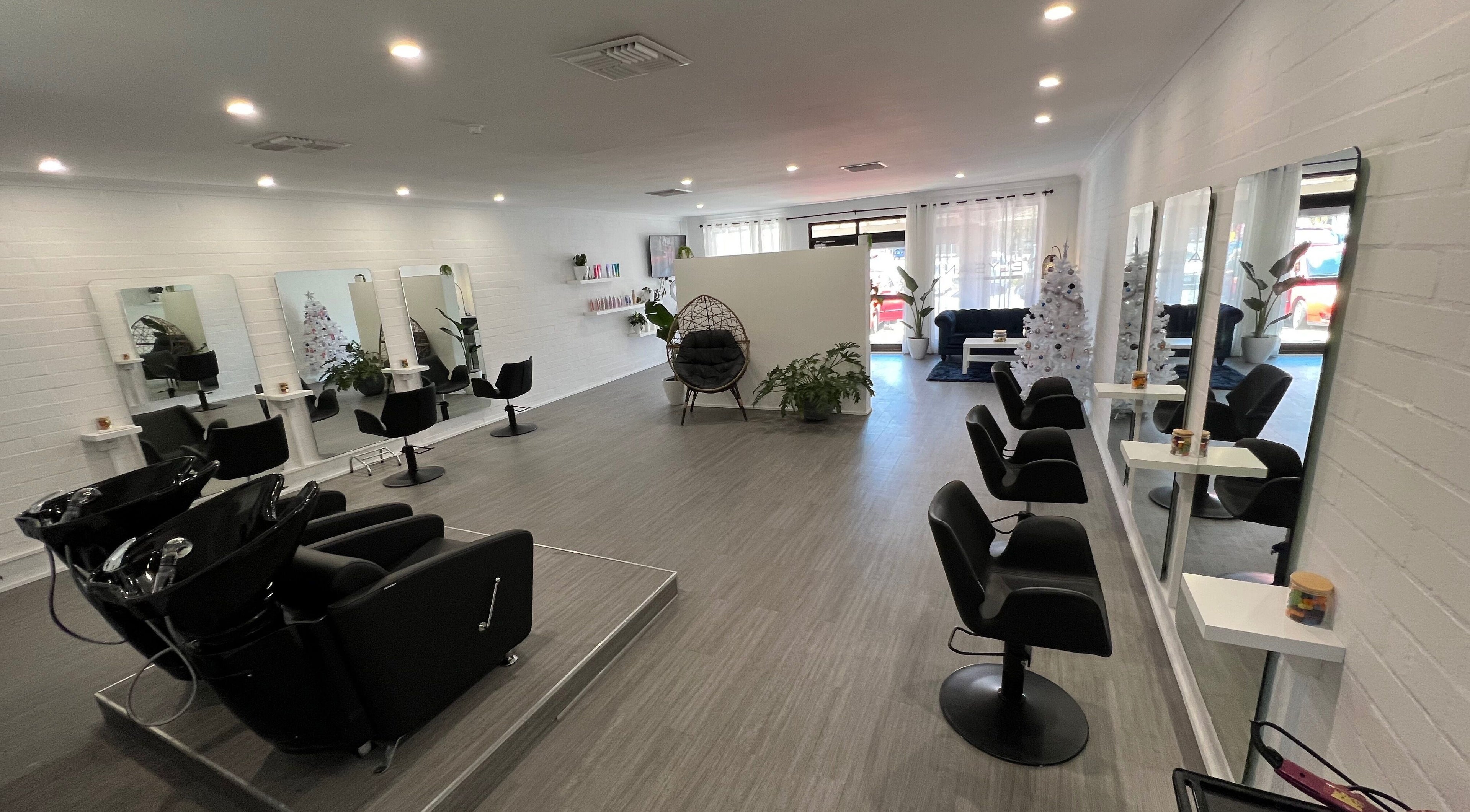 Modern interior of Elysian Hair Artistry in Bayswater, WA, featuring sleek styling stations.