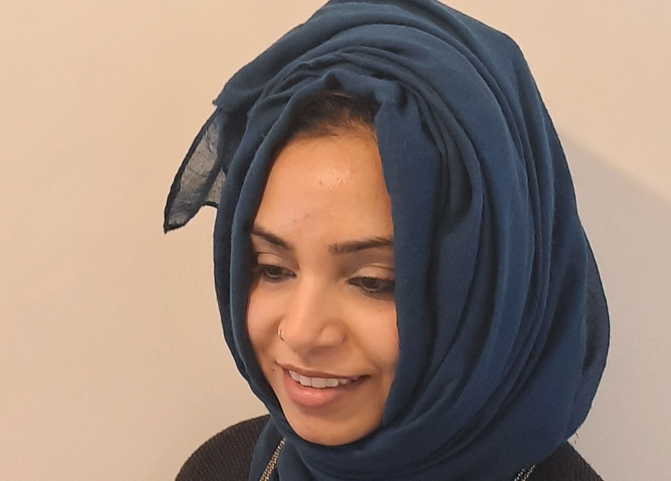 Woman smiling at Soul Bliss with Sayyada, Tamworth, England, GB. She wears a blue headscarf.