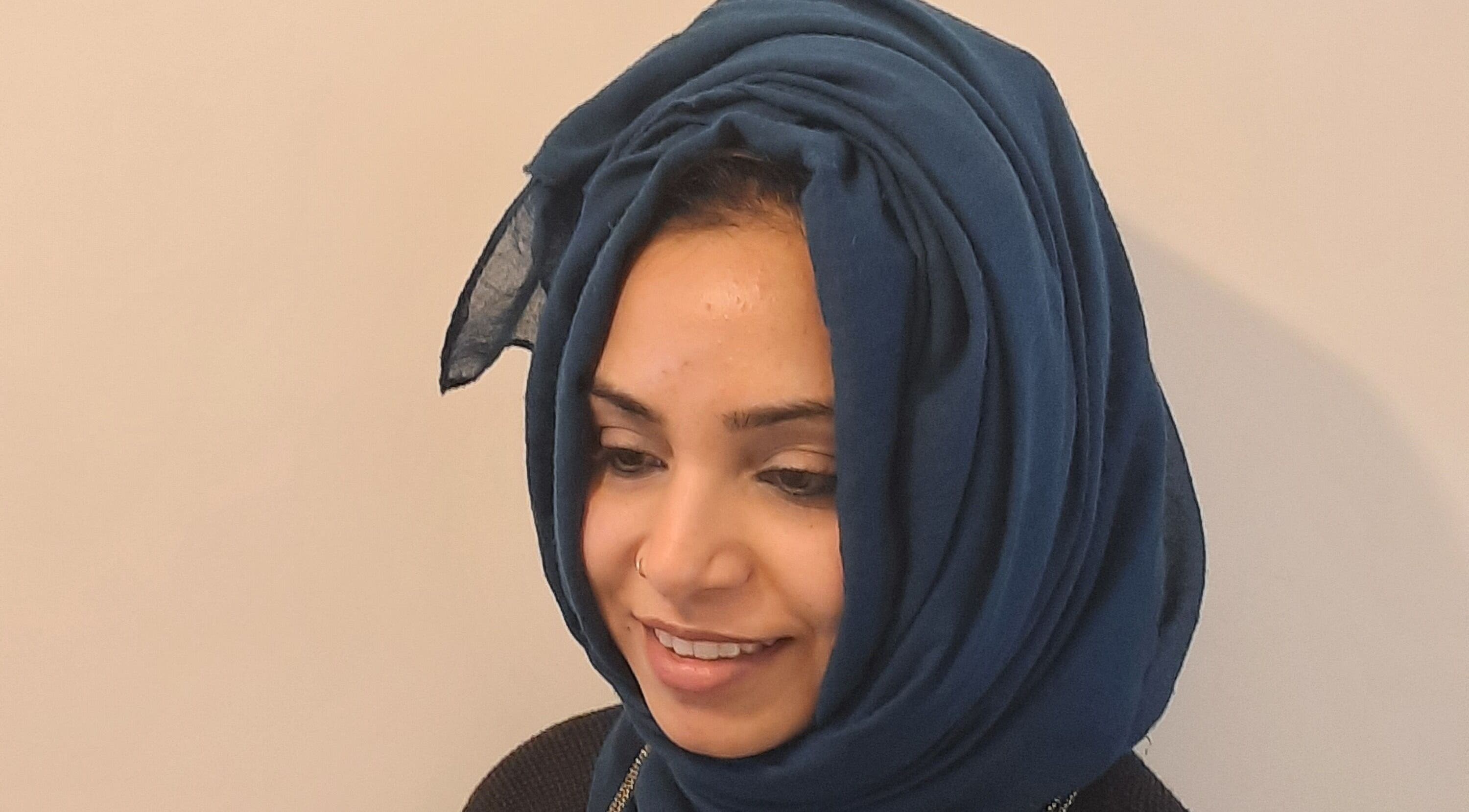 Woman smiling at Soul Bliss with Sayyada, Tamworth, England, GB. She wears a blue headscarf.