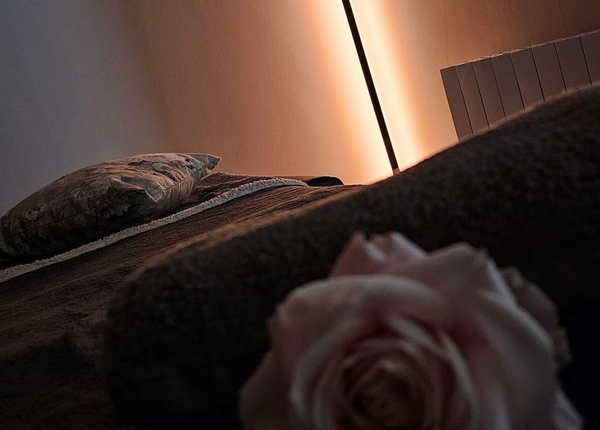 Tranquil treatment room at Soul Bliss with Sayyada in Tamworth, England, GB, featuring soft lighting and a cozy bed.