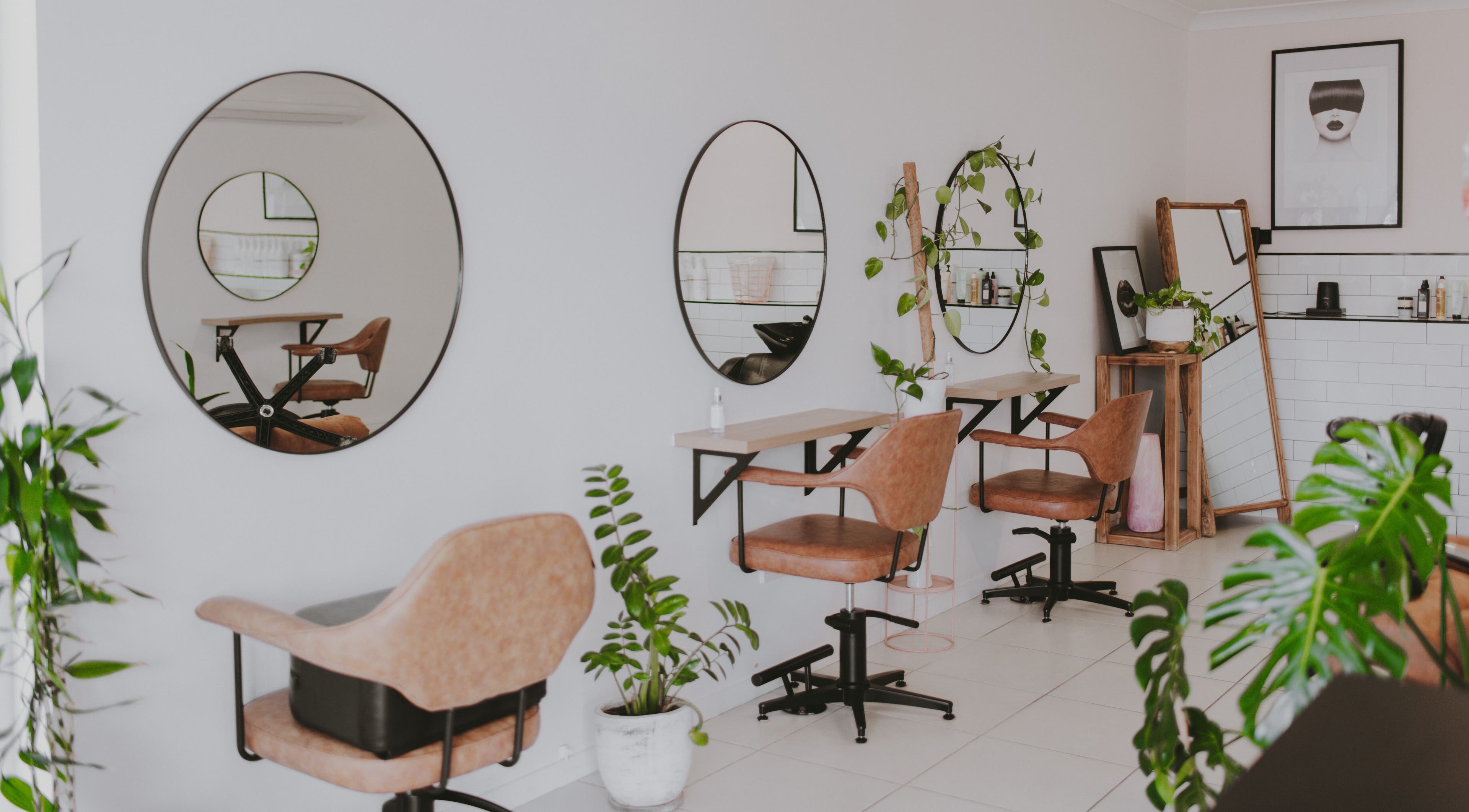 Modern interior of Birdee Hair Boutique in Allenstown, Queensland, AU showcasing chic styling stations and mirrors.