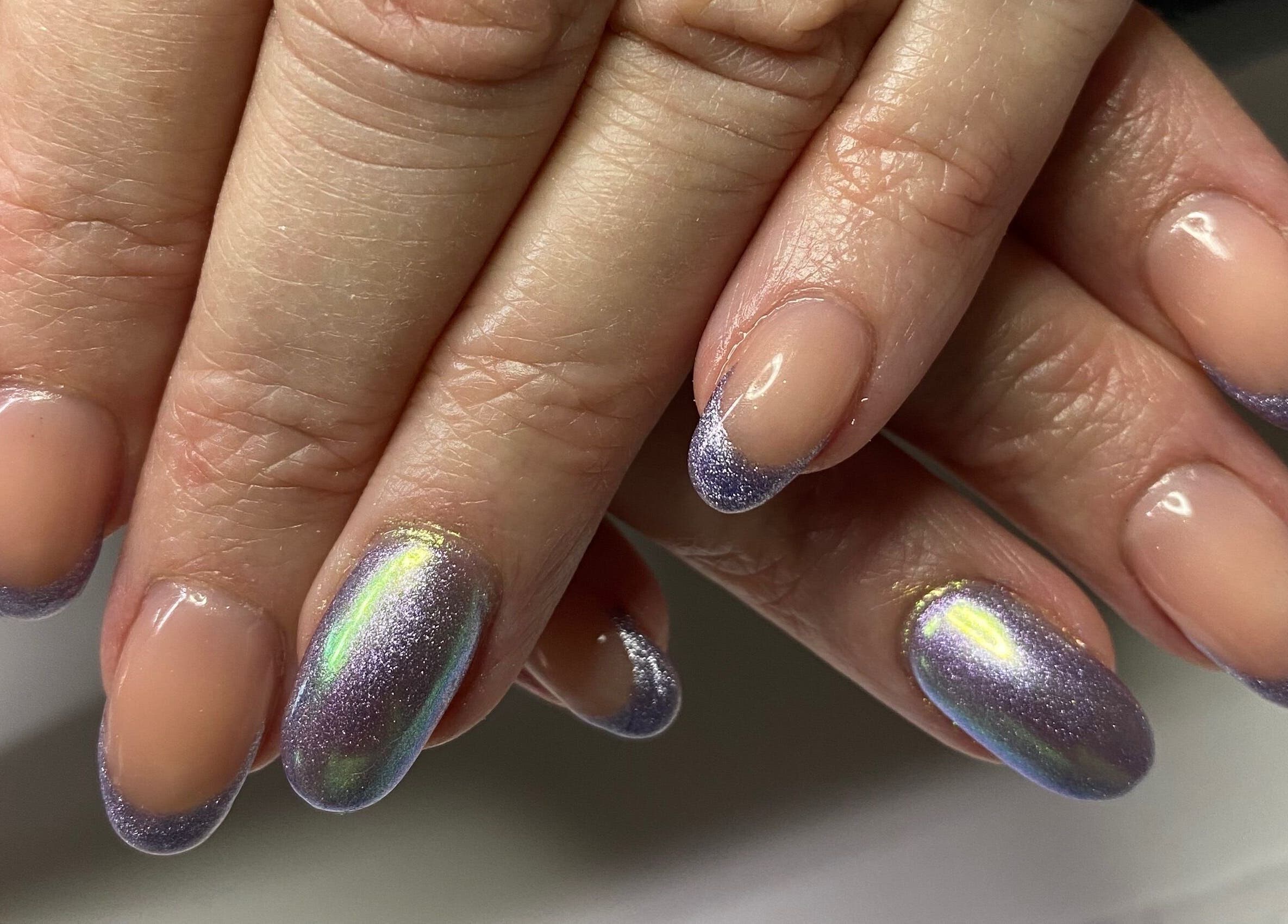 Elegant purple-glitter nails showcase Infinite salon's artistry in Benoni, Gauteng, ZA.