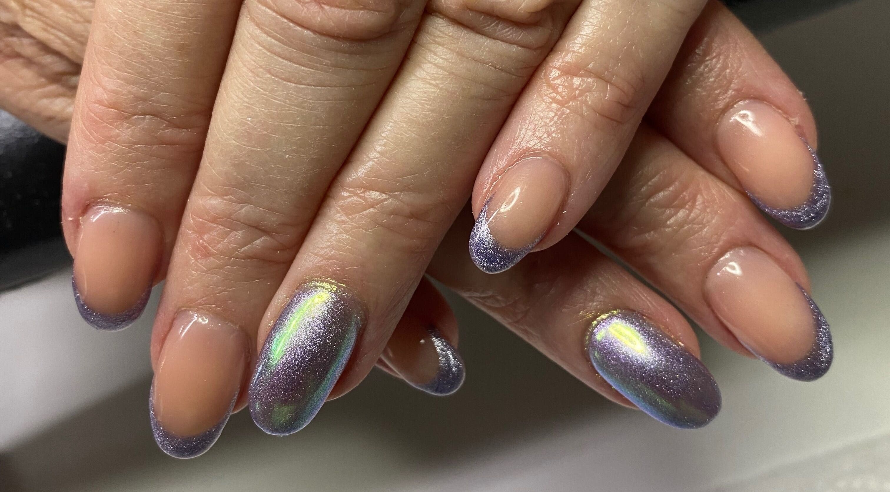 Elegant purple-glitter nails showcase Infinite salon's artistry in Benoni, Gauteng, ZA.