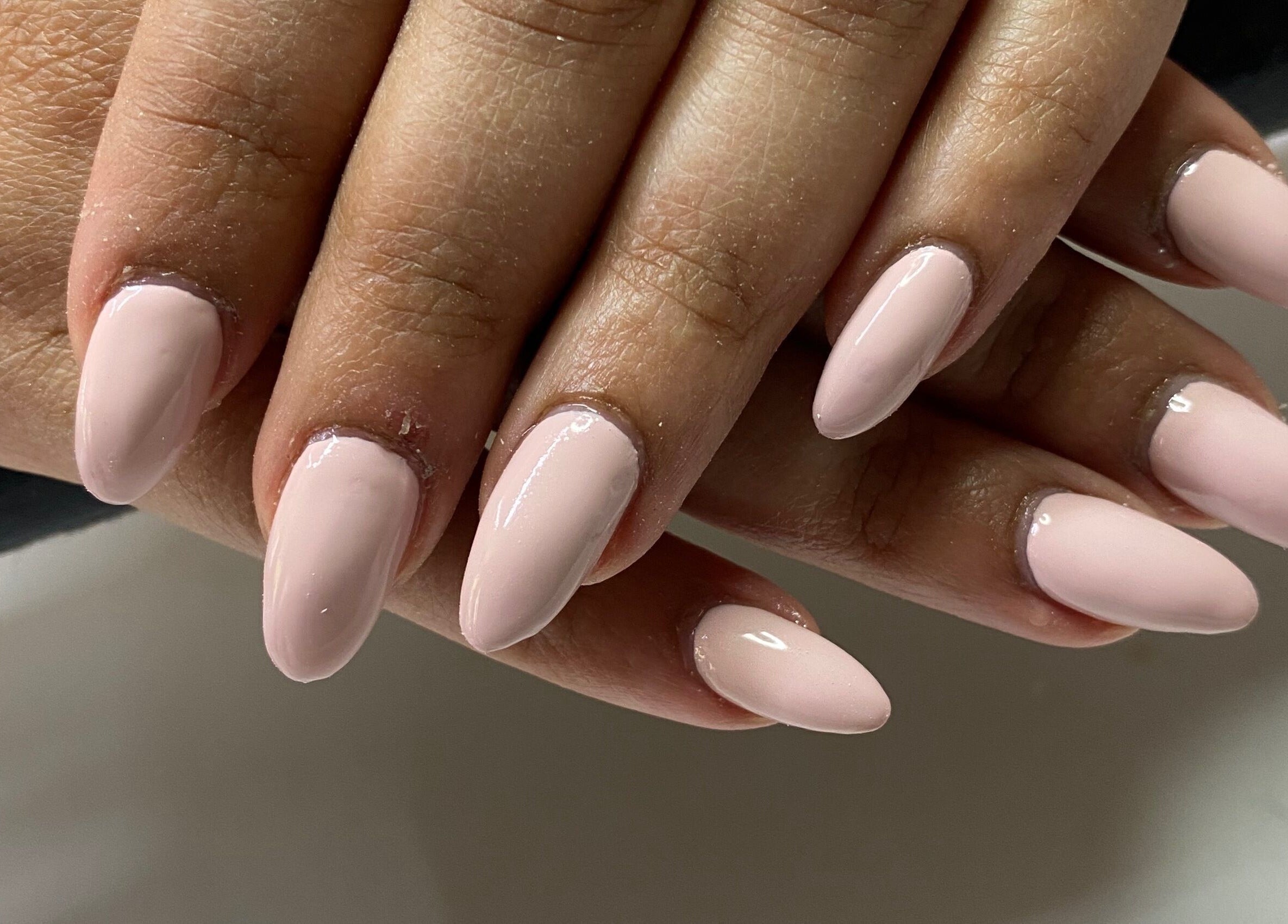 Manicured nails with light pink polish at Infinite, Benoni, Gauteng, ZA.