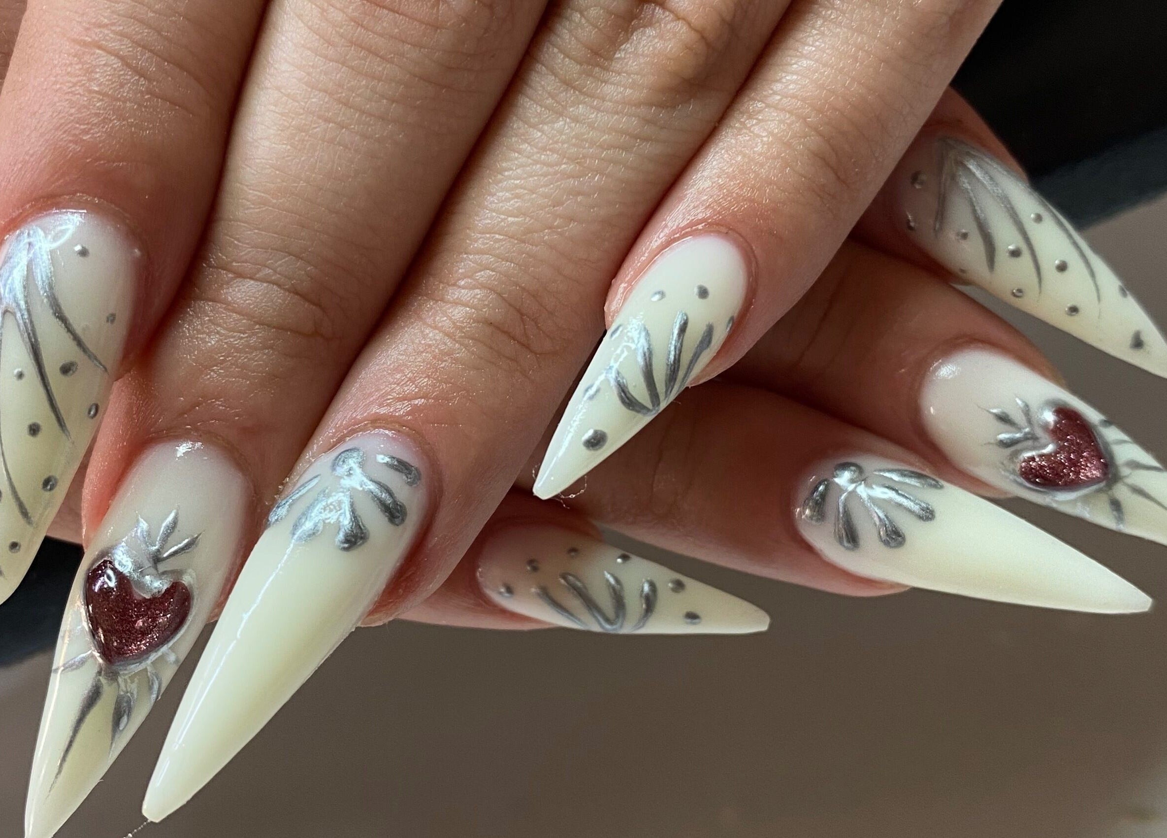 Elegant nail art with heart design at Infinite, Benoni, Gauteng, ZA, showcasing intricate styling.