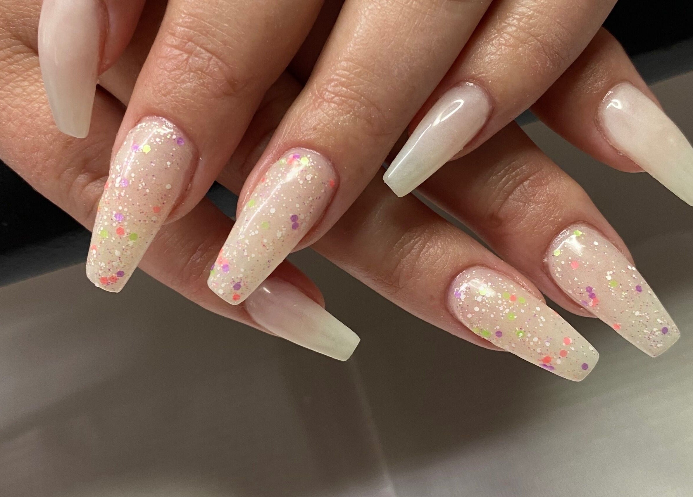 Elegant nail art with glittering tips at Infinite, Benoni, Gauteng, ZA, showcasing expert manicure services.