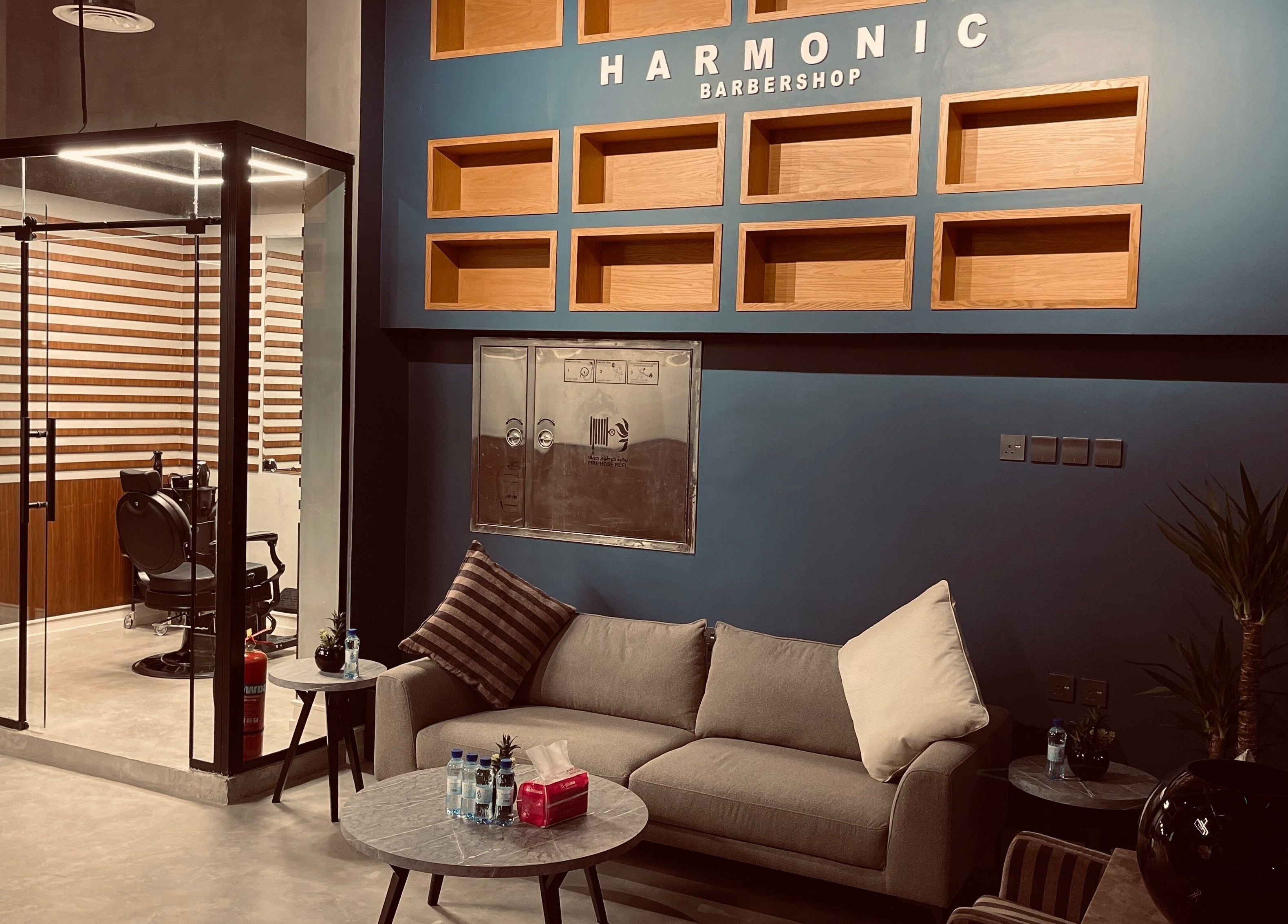 Relaxing lounge area in Harmonic Barbershop - Al Malqa, Riyadh, Riyadh Province, SA with plush seating and decor.