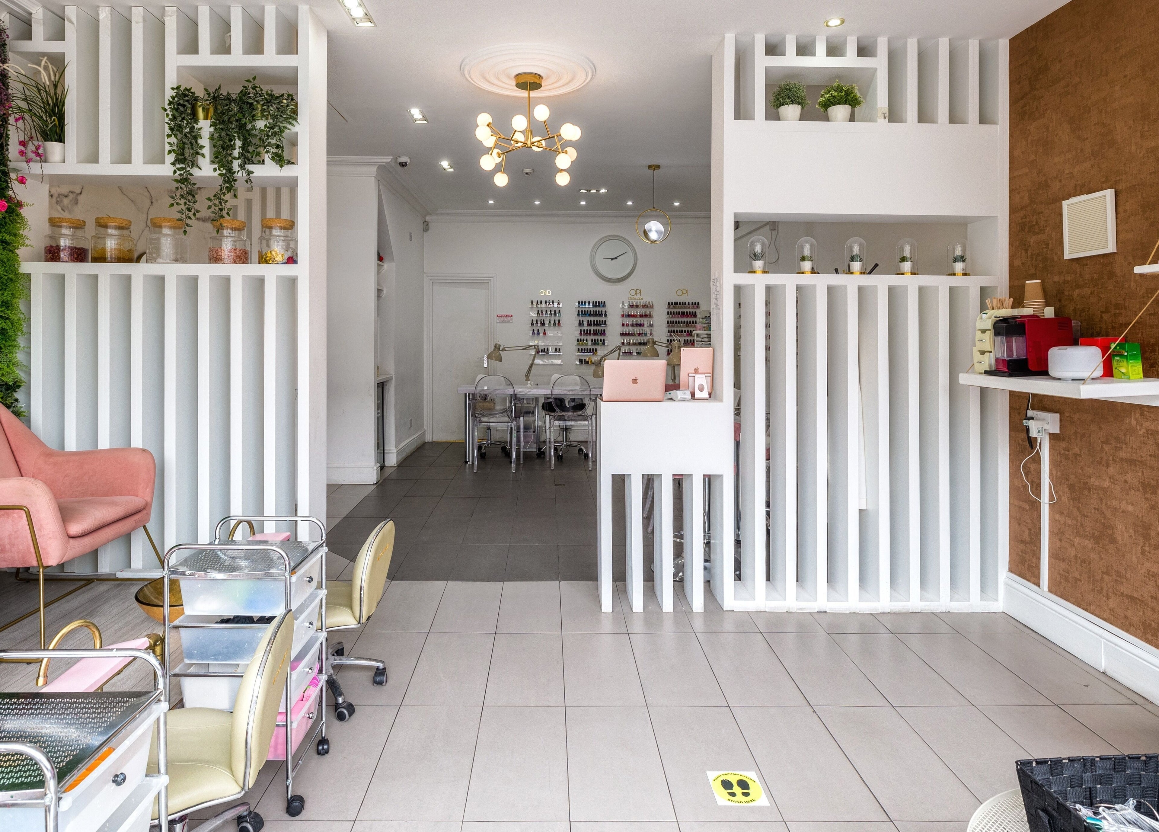 Explore the modern interior of Blush Nail Bar in London, England, GB with elegant seating and nail care stations.
