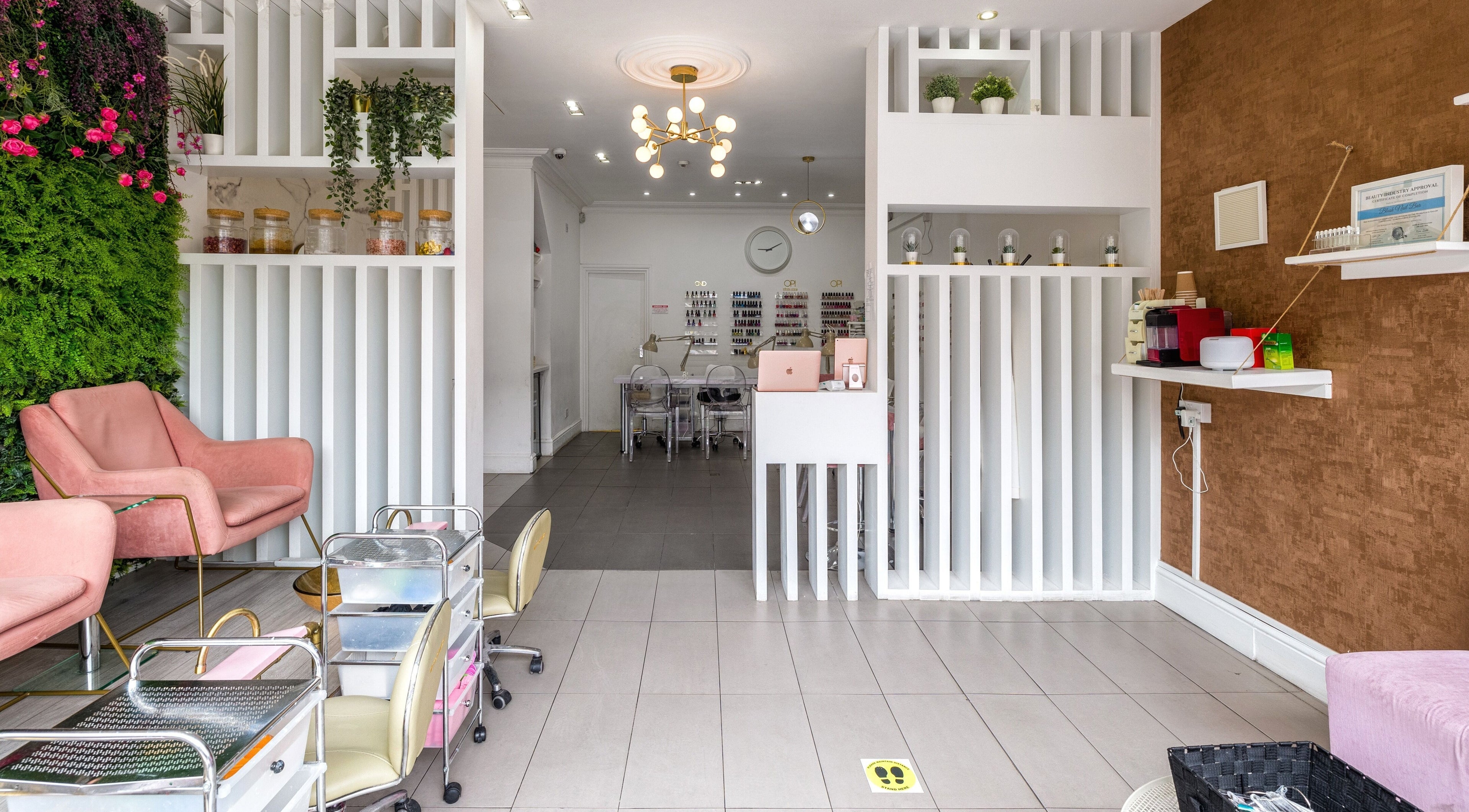 Explore the modern interior of Blush Nail Bar in London, England, GB with elegant seating and nail care stations.