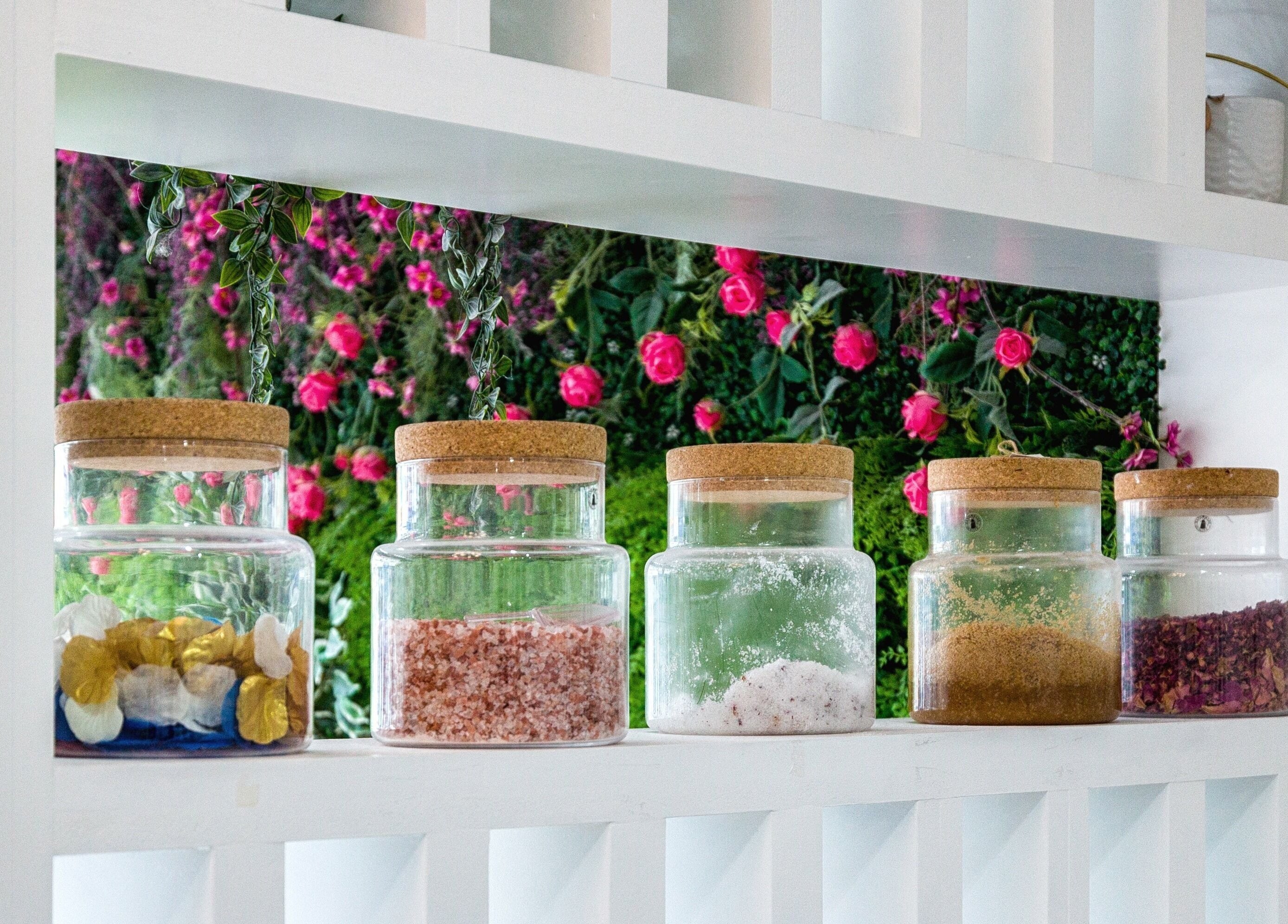 Glass jars with spa salts and botanicals at Blush Nail Bar, London, England, GB, enhancing ambiance.