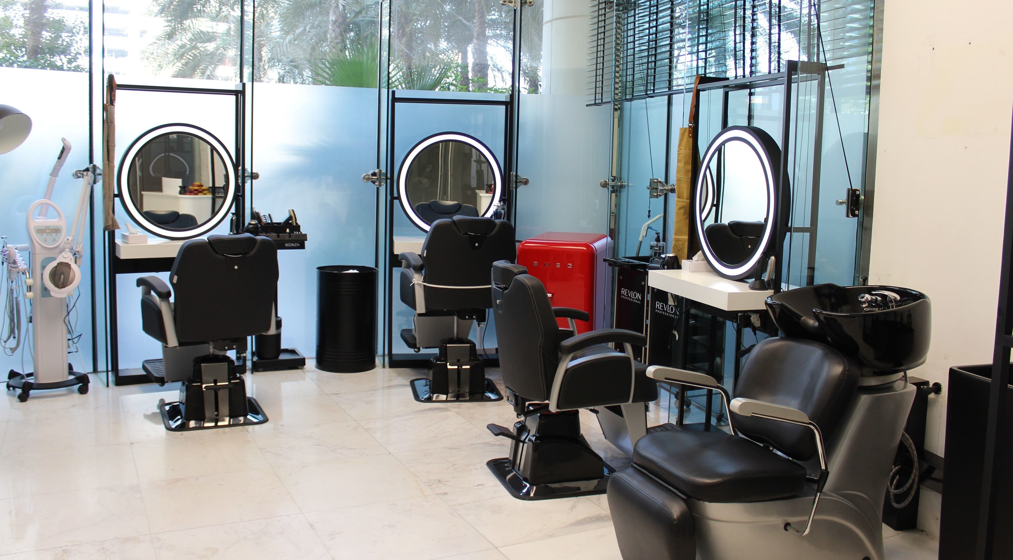 Modern salon chairs and mirrors at Bulls and Barbers - Media City, Dubai, Dubai, AE.