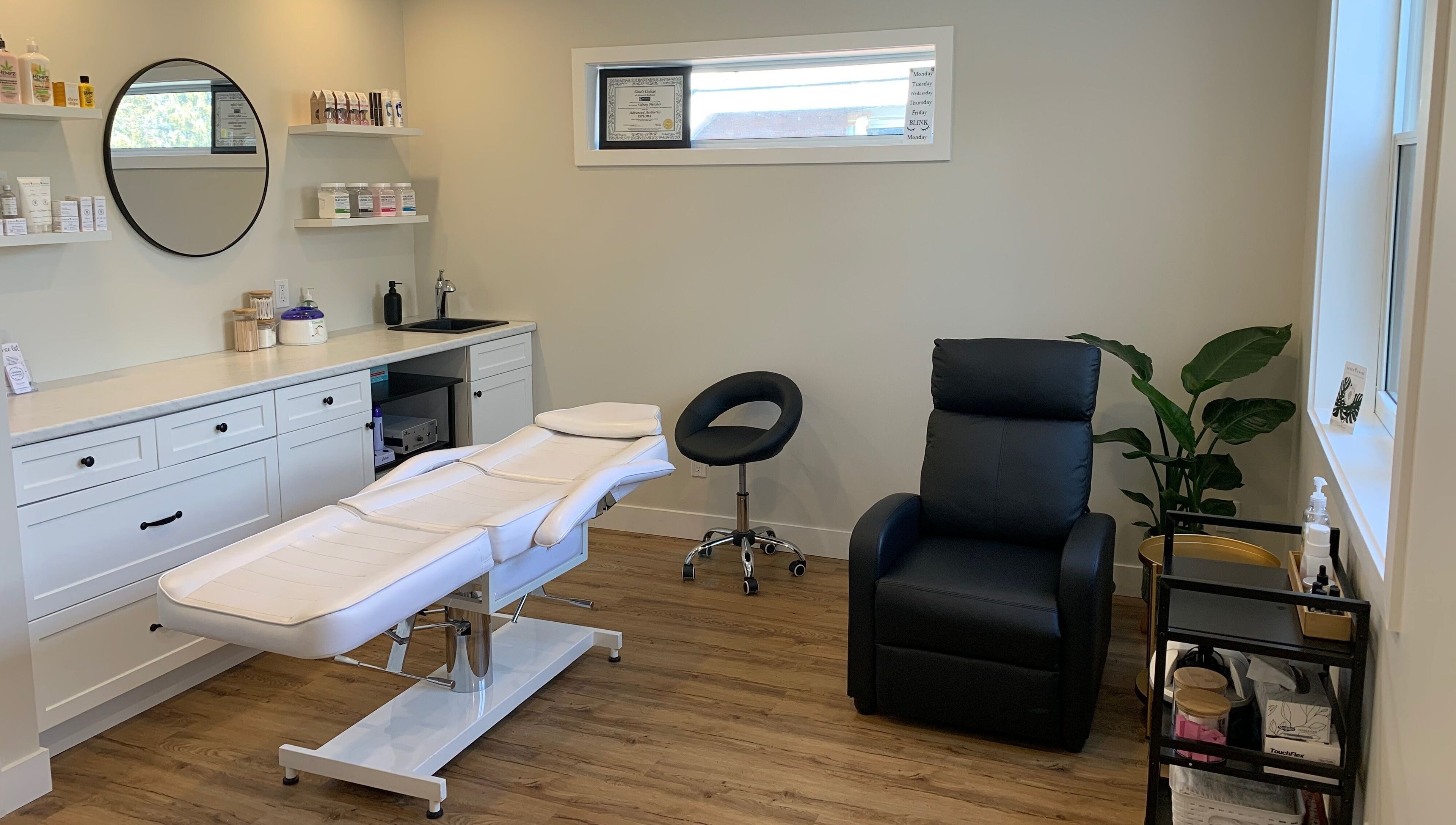 Relaxing treatment room at Sidney Aesthetics, Owen Sound, Ontario, CA with sleek decor and comfortable seating.