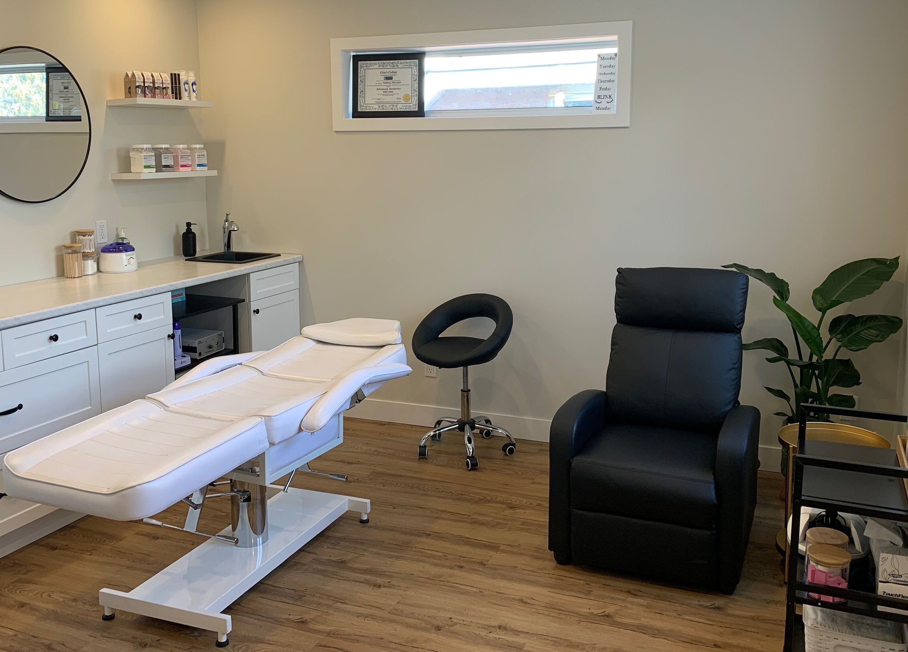 Relaxing treatment room at Sidney Aesthetics, Owen Sound, Ontario, CA with sleek decor and comfortable seating.