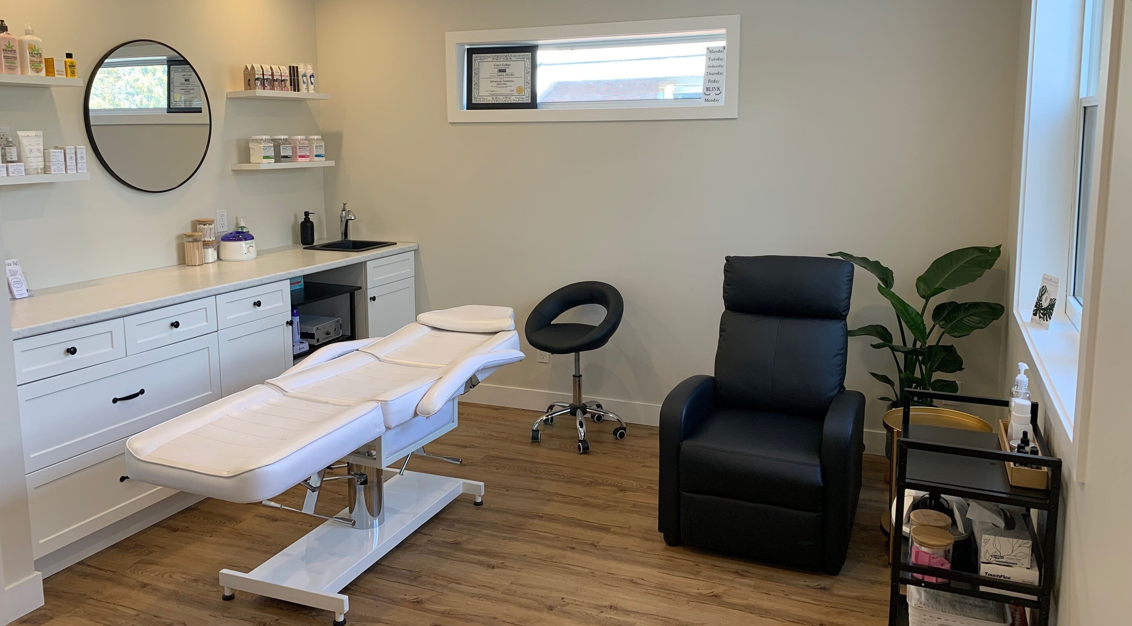 Relaxing treatment room at Sidney Aesthetics, Owen Sound, Ontario, CA with sleek decor and comfortable seating.