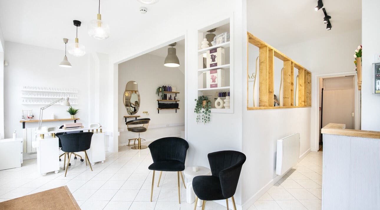 Spacious, chic interior of Megan Gribbon Hair salon in Torquay, England, GB with modern decor and seating.