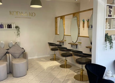 Elegant hair salon interior at Megan Gribbon Hair, Torquay, England, GB featuring stylish seating and mirrors.