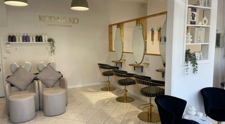 Elegant hair salon interior at Megan Gribbon Hair, Torquay, England, GB featuring stylish seating and mirrors.