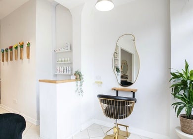 Chic salon interior at Megan Gribbon Hair, Torquay, England, GB with a stylish chair and modern decor.