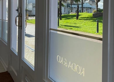 Inviting entryway of Megan Gribbon Hair in Torquay, England, GB showcasing natural light and outdoor greenery.