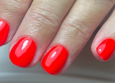 Vibrant red manicure by Brooke Coles at Blackwood, Wales, GB, showcasing impeccable nail art.