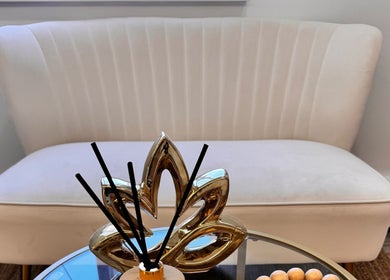 Chic white sofa with a decorative centerpiece at Brazilian Beauty Spa, Peabody, Massachusetts, US.