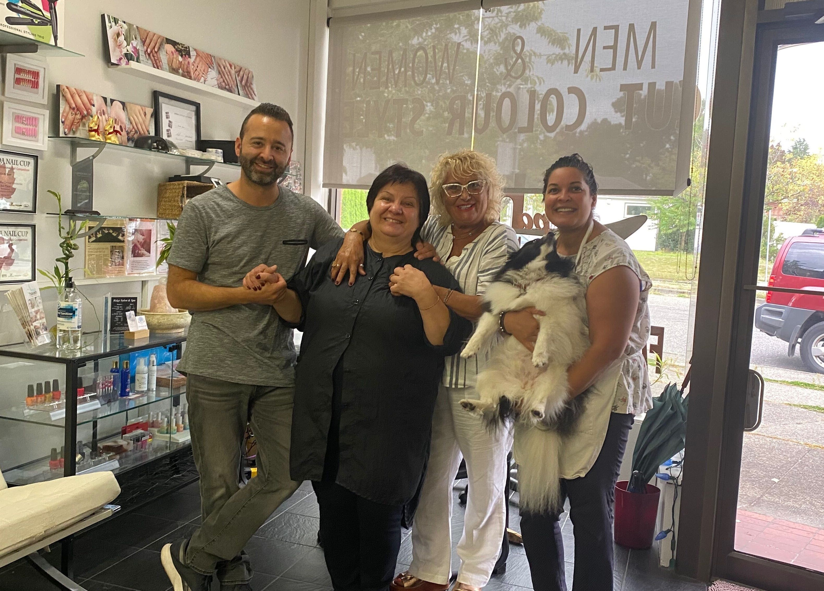 Friendly staff at Salon and Spa Haven Wellness, Vancouver, British Columbia, CA, smiling with a fluffy dog.