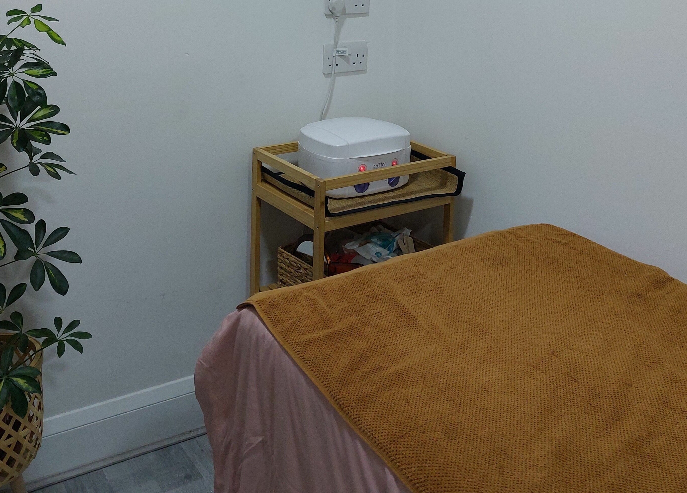 Relaxing treatment room with plants and warming equipment at T'Studio, Basingstoke, England, GB.