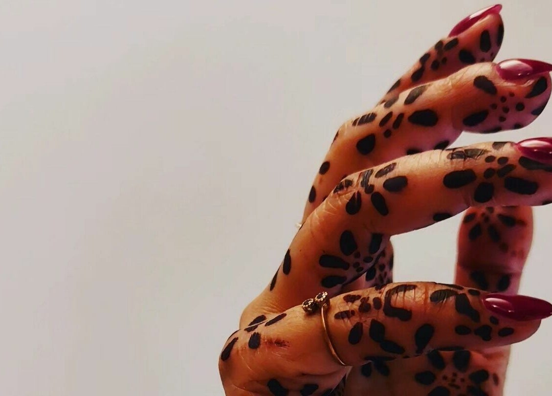 Hand with intricate henna design and elegant nails at T'Studio, Basingstoke, England, GB.