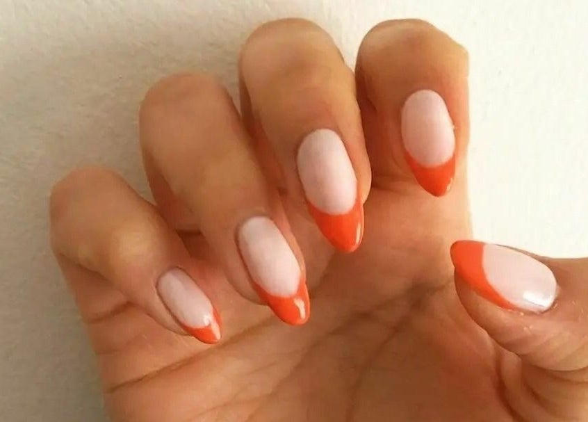 Stylish coral French manicure at T'Studio, Basingstoke, England, GB. Perfectly shaped nails with glossy finish.