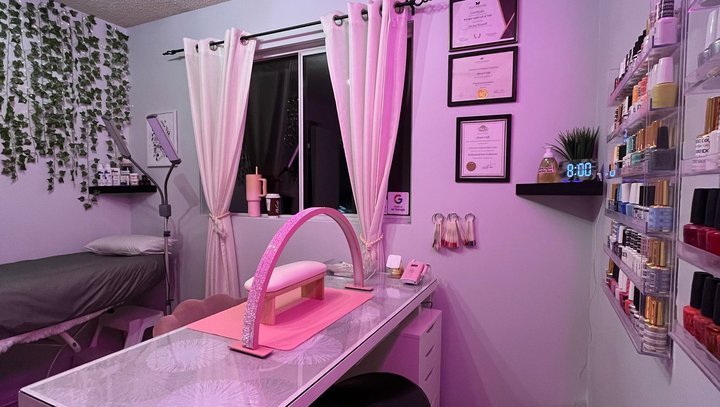 Cozy Esthetics by Lyss beauty room in Nanaimo, British Columbia, CA with pink lighting and nail supplies.