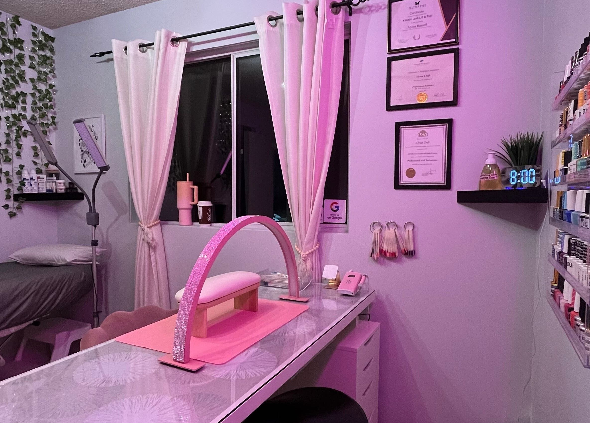 Cozy Esthetics by Lyss beauty room in Nanaimo, British Columbia, CA with pink lighting and nail supplies.