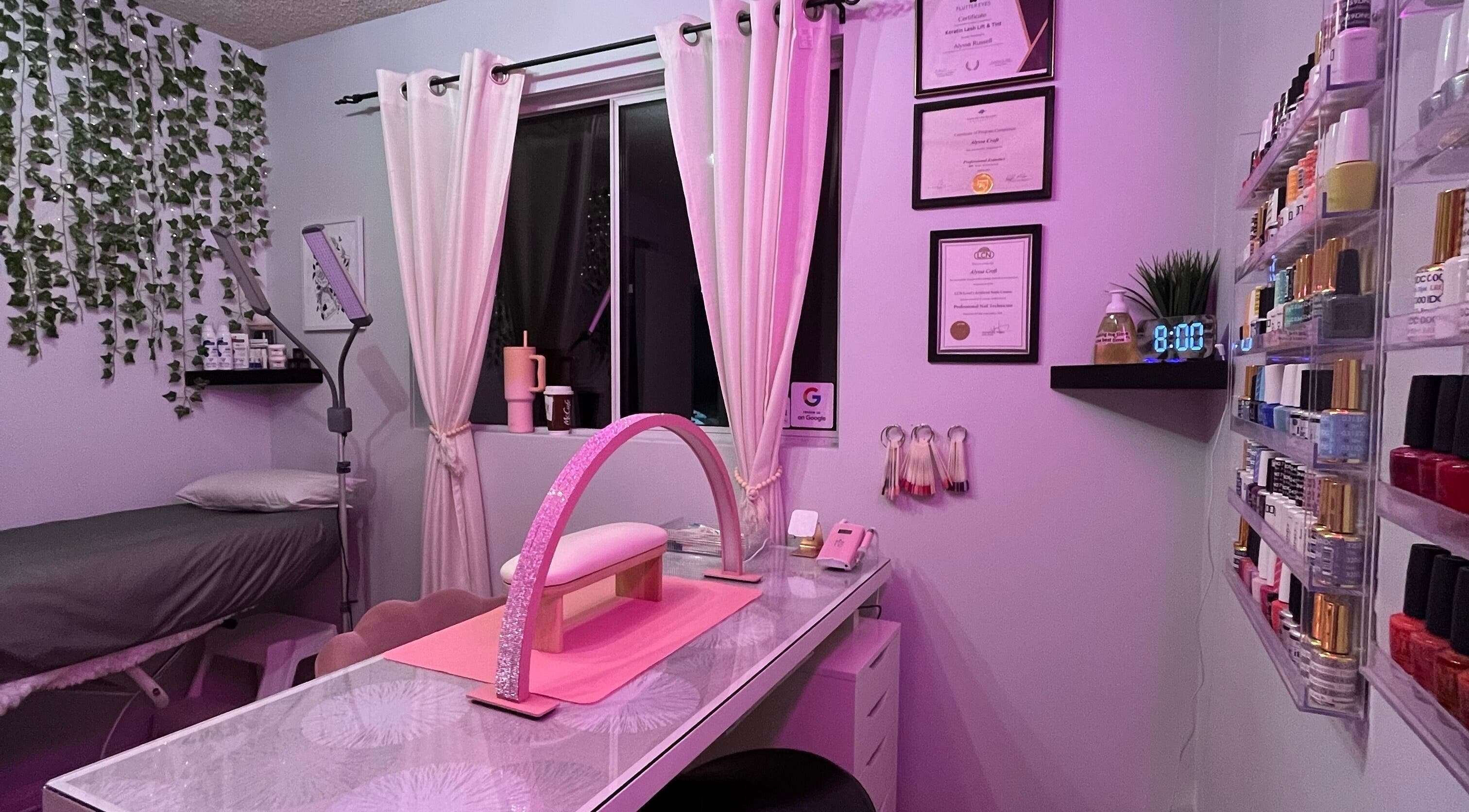 Cozy Esthetics by Lyss beauty room in Nanaimo, British Columbia, CA with pink lighting and nail supplies.