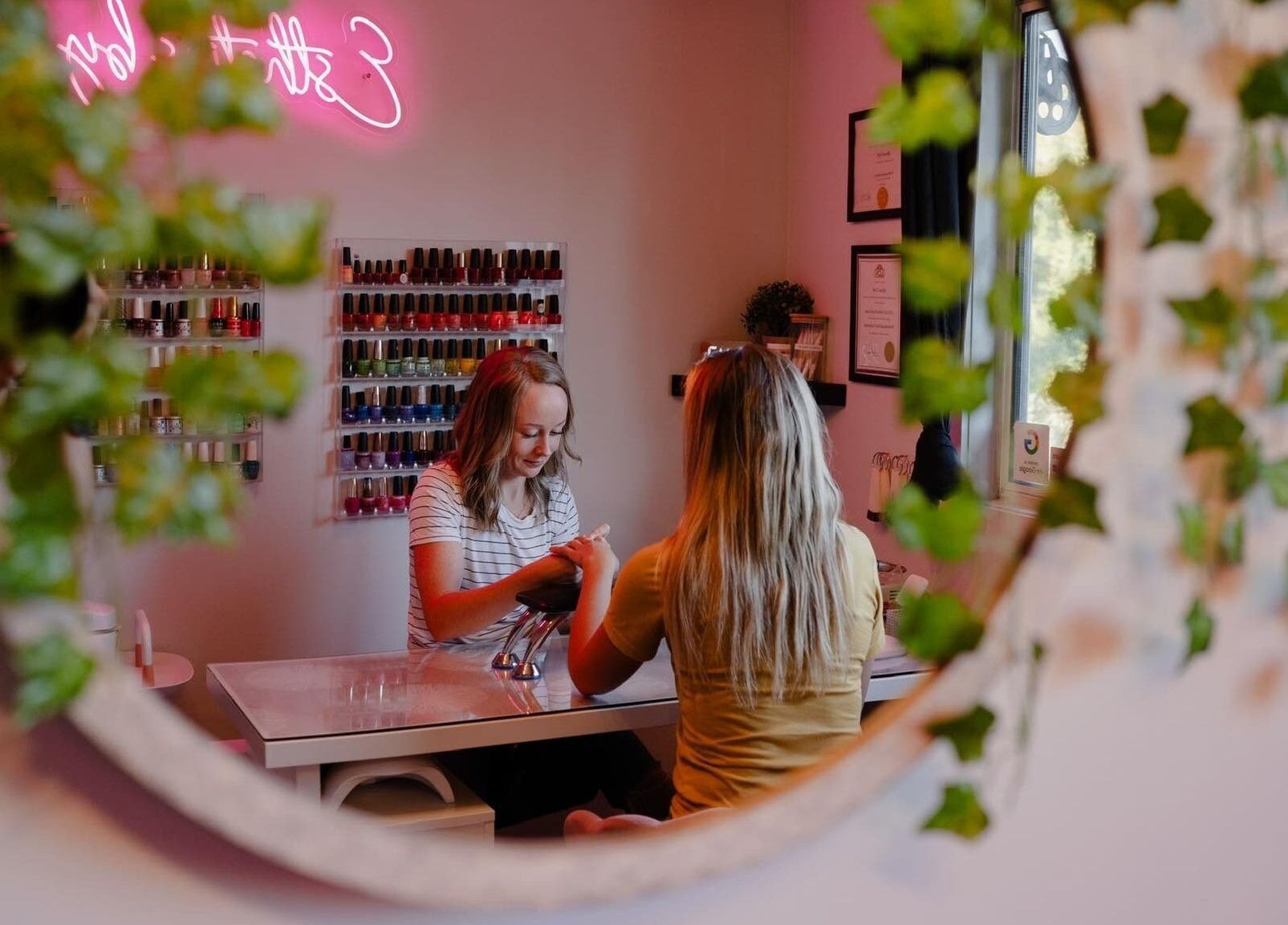 A serene manicure session at Esthetics by Lyss in Nanaimo, British Columbia, CA, reflected in a decorative mirror.