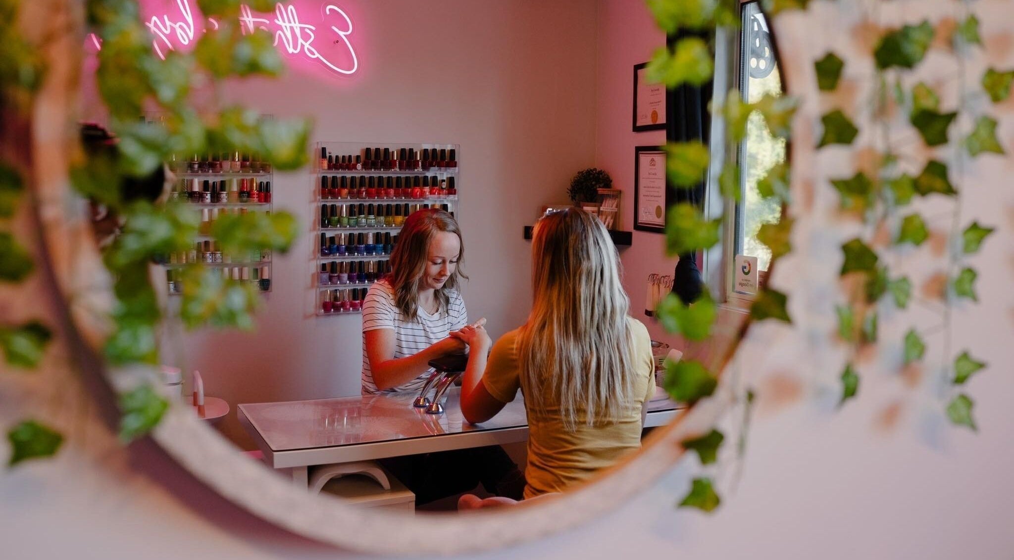 A serene manicure session at Esthetics by Lyss in Nanaimo, British Columbia, CA, reflected in a decorative mirror.