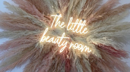 Vibrant neon sign reading 'The Little Beauty Room' surrounded by decorative pampas grass in Bowburn, England, GB.