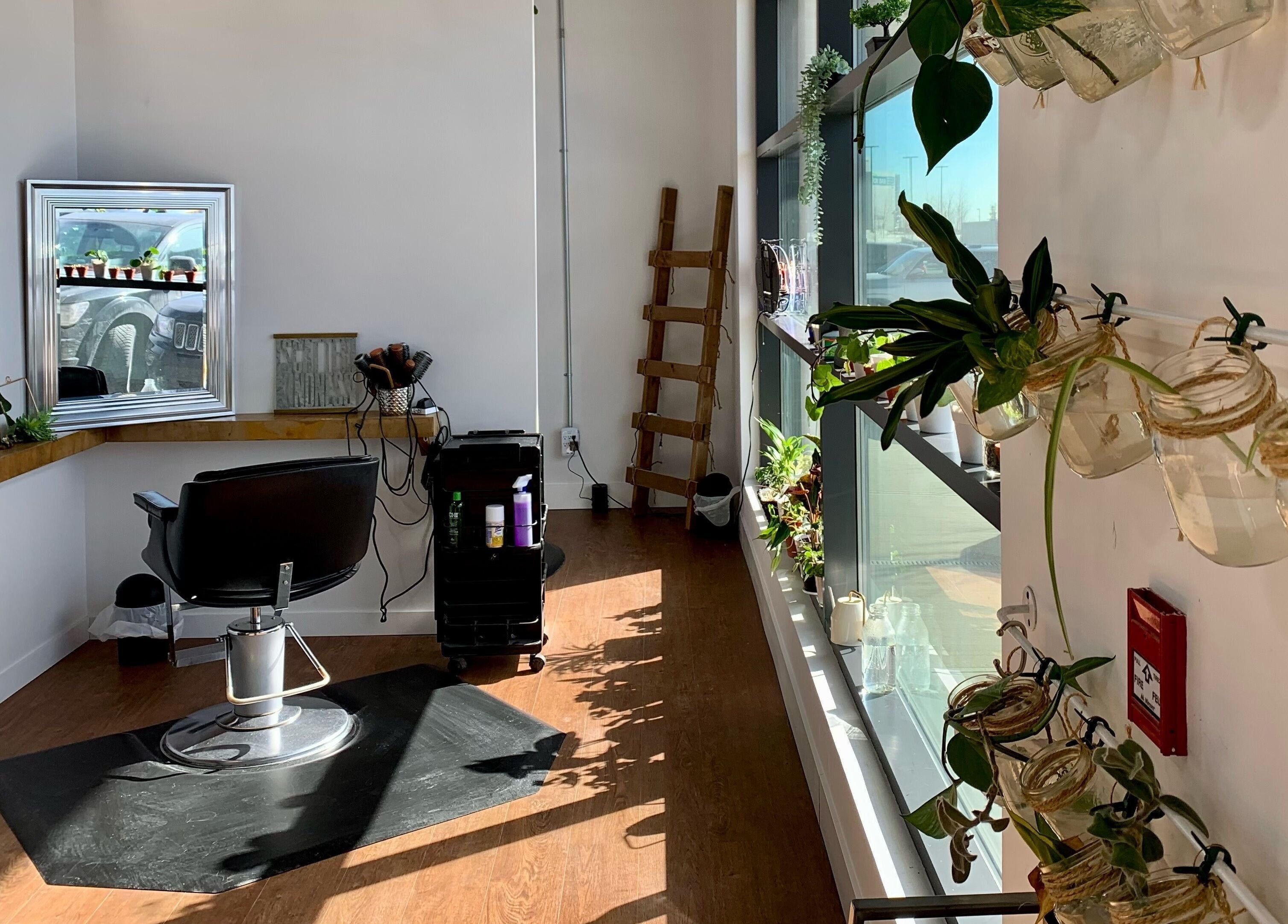 Bright styling station at Turning Heads Hair Studio, Calgary, Alberta, CA, with plants and salon essentials.