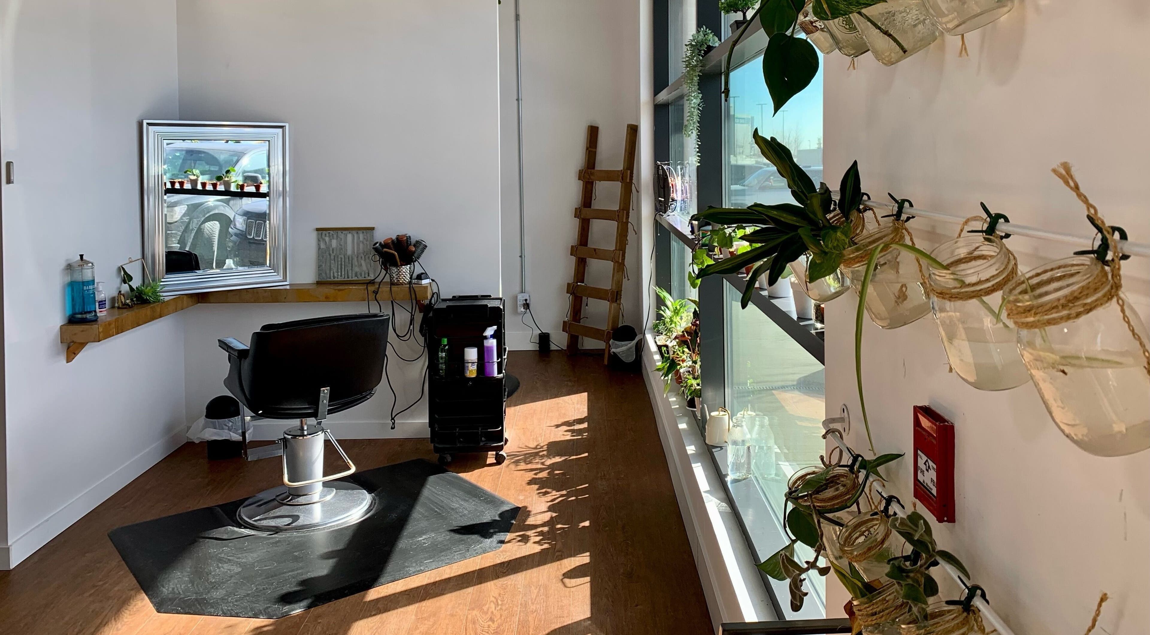 Bright styling station at Turning Heads Hair Studio, Calgary, Alberta, CA, with plants and salon essentials.